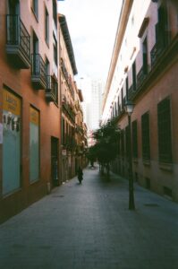Narrow street lined with buildings and trees